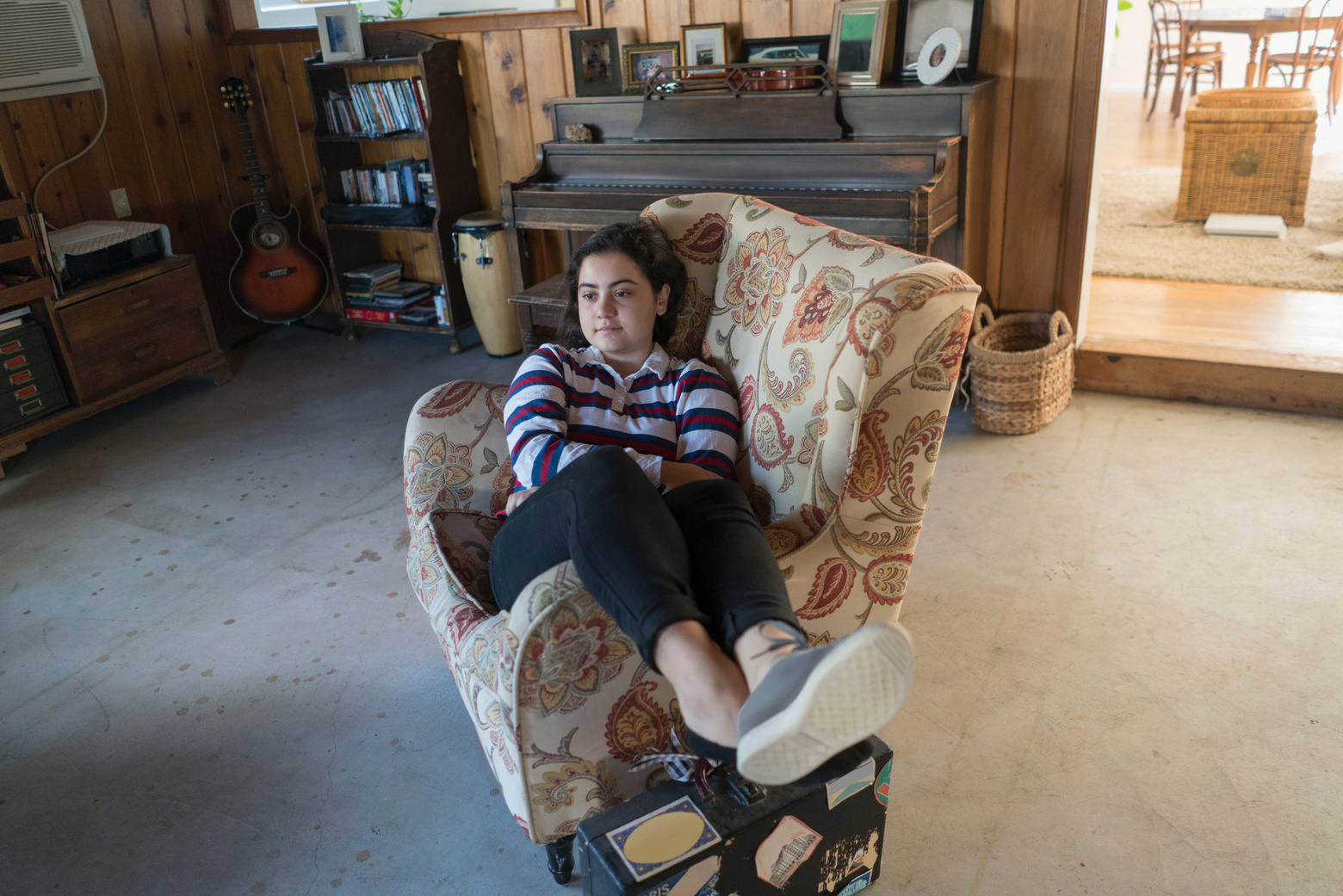 hispanic teenage girl in comfy chair